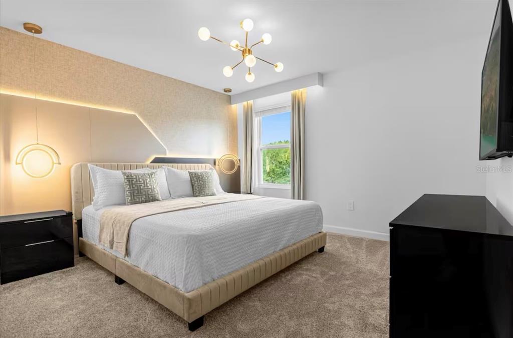 2992 Penelope Loop Kissimmee, FL 34746 - Photo 39 of 83 a bedroom with bed and a chandelier