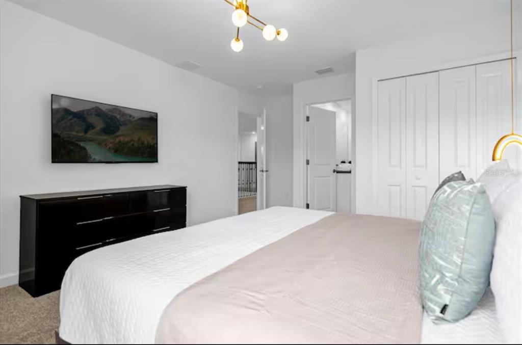 2992 Penelope Loop Kissimmee, FL 34746 - Photo 40 of 83 a bedroom with a bed and a flat screen tv