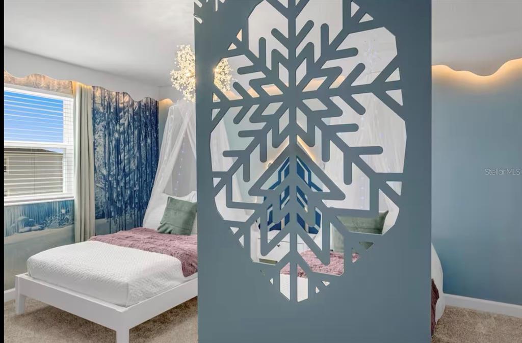 2992 Penelope Loop Kissimmee, FL 34746 - Photo 42 of 83 a bedroom with a bed and a chandelier