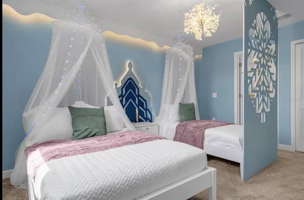 2992 Penelope Loop Kissimmee, FL 34746 - Photo 44 of 83 a bedroom with bed and a chandelier