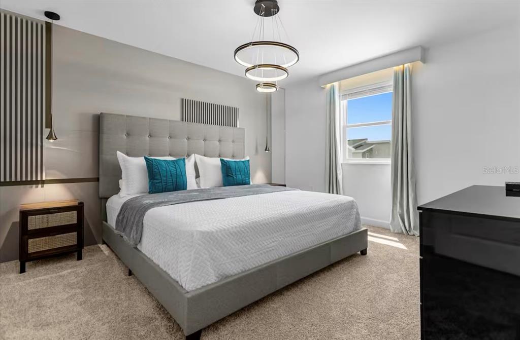 2992 Penelope Loop Kissimmee, FL 34746 - Photo 50 of 83 a bedroom with a bed and a night stand