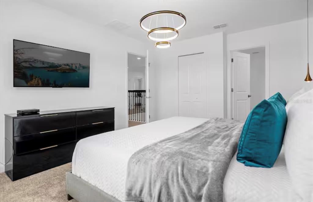 2992 Penelope Loop Kissimmee, FL 34746 - Photo 52 of 83 a bedroom with a bed and a television