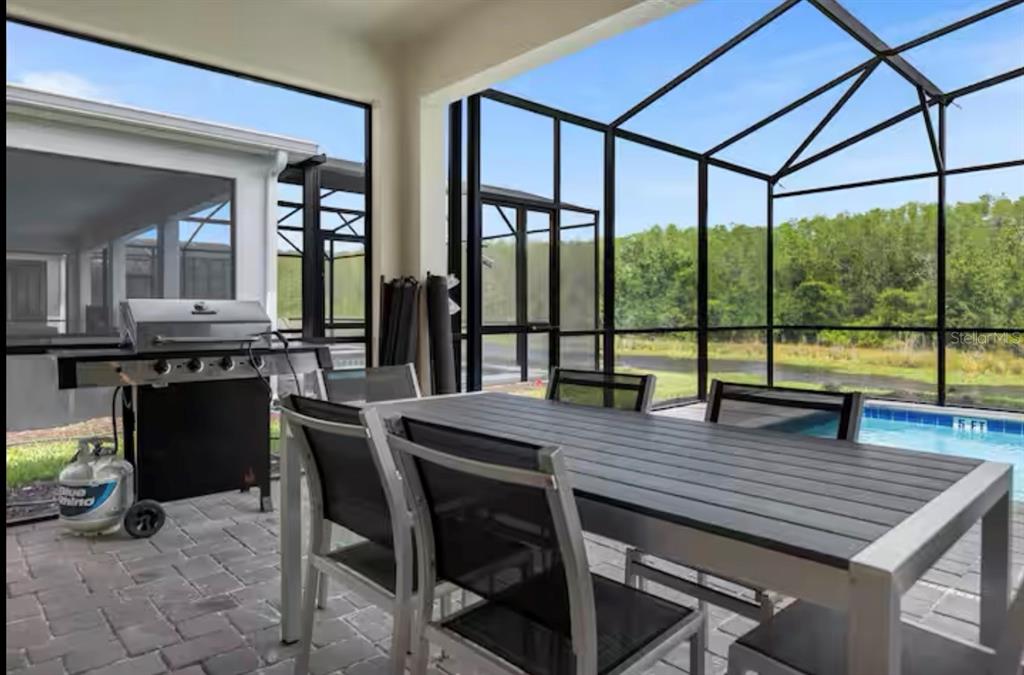 2992 Penelope Loop Kissimmee, FL 34746 - Photo 60 of 83 a view of a dining room with furniture window and wooden floor