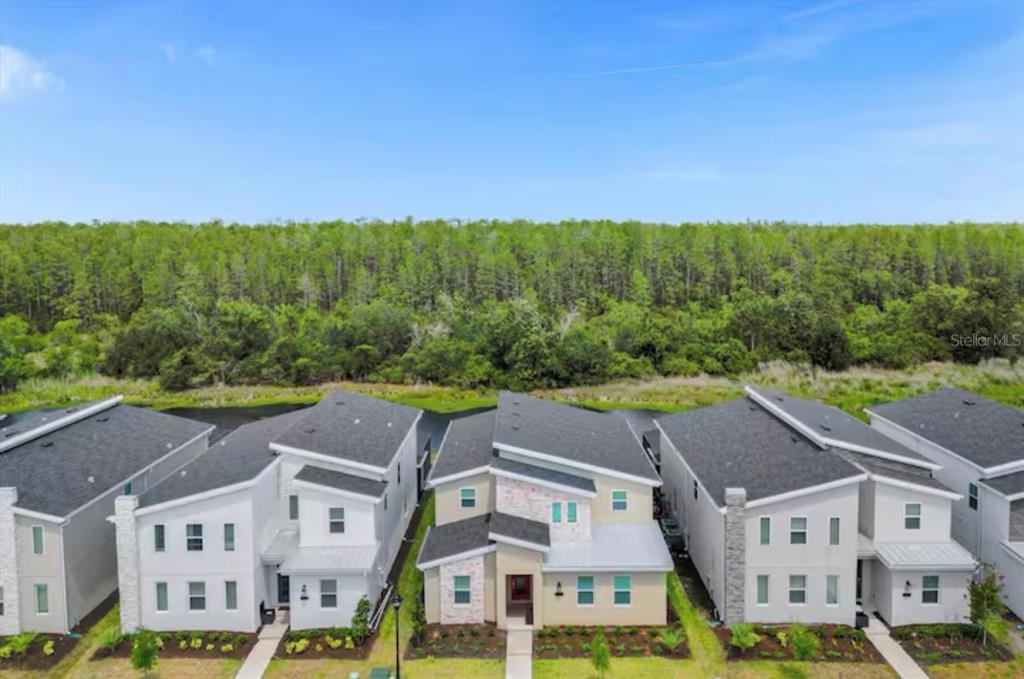 2992 Penelope Loop Kissimmee, FL 34746 - Photo 61 of 83 an aerial view of multiple houses with a yard