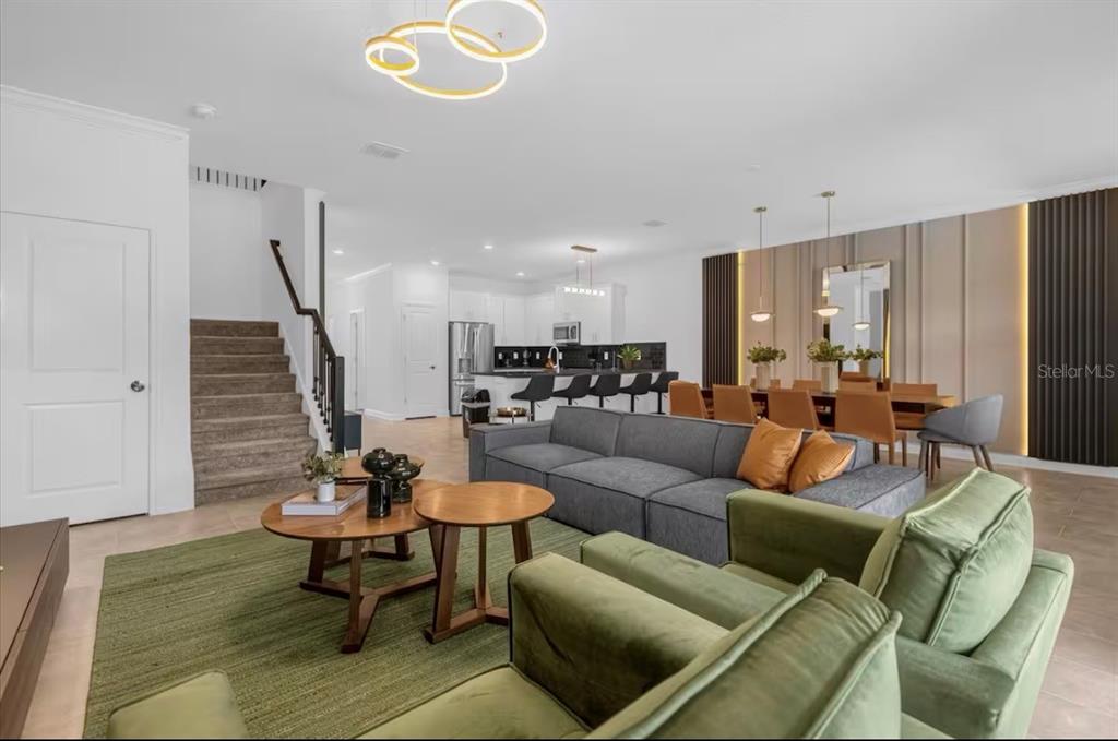 2992 Penelope Loop Kissimmee, FL 34746 - Photo 7 of 83 a living room with furniture kitchen view and a wooden floor