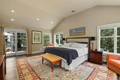 a large bedroom with a bed and a flat screen television
