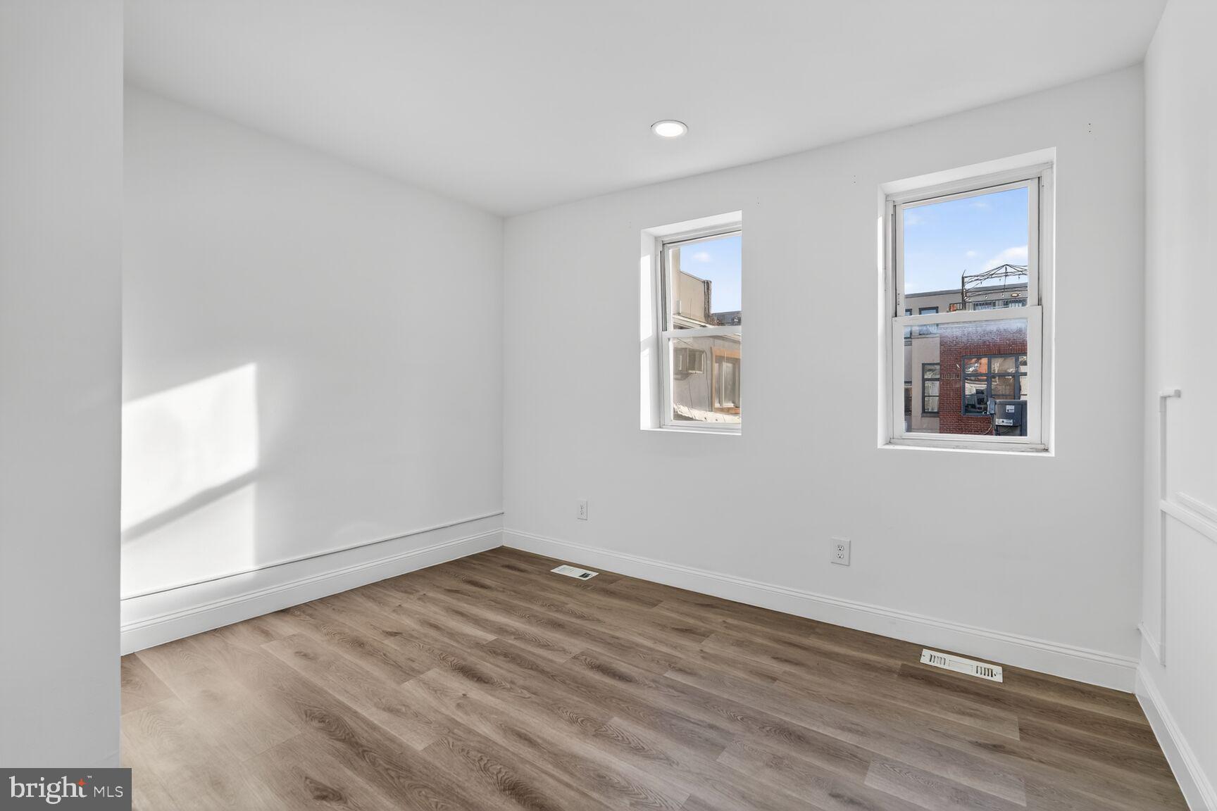 2409 18th Street Northwest, Unit 2 Washington, DC 20009 - Photo 18 of 19 an empty room with wooden floor and windows