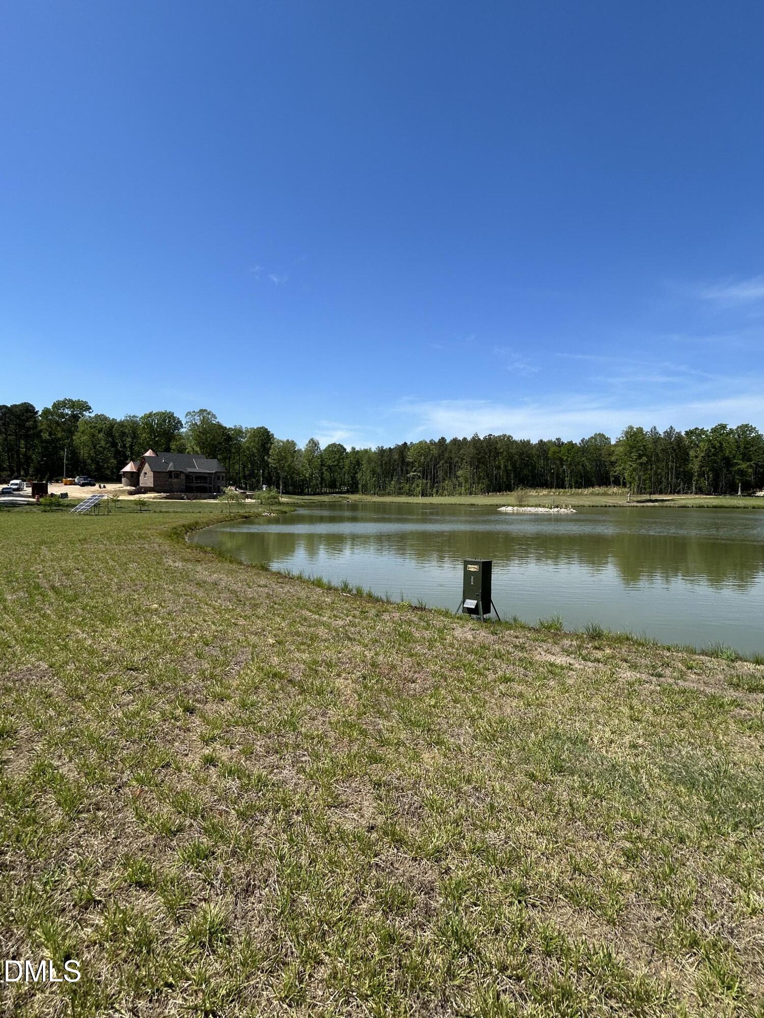 230 Bealy Farm Road Zebulon, NC 27597 - Photo 6 of 12 a view of a lake with houses in the back