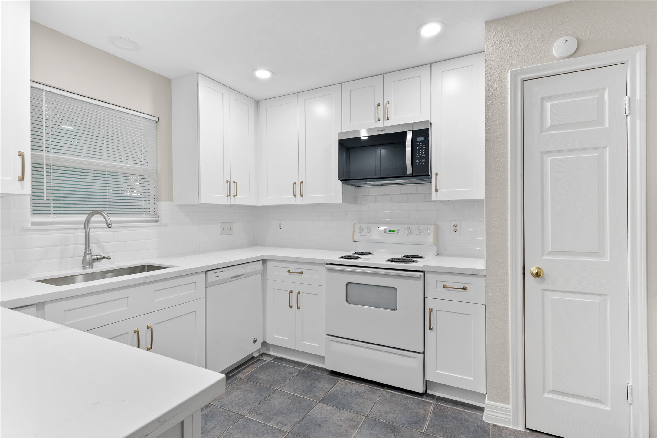 8314 Poplar Ridge Lane Humble, TX 77338 - Photo 9 of 20 a kitchen with white cabinets stainless steel appliances and sink