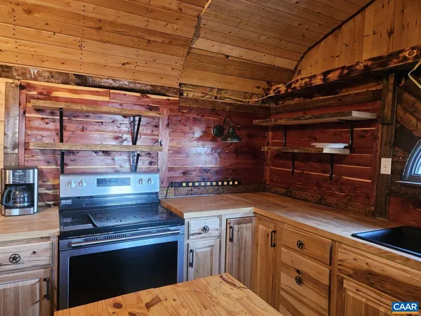 a kitchen with granite countertop a stove and cabinets