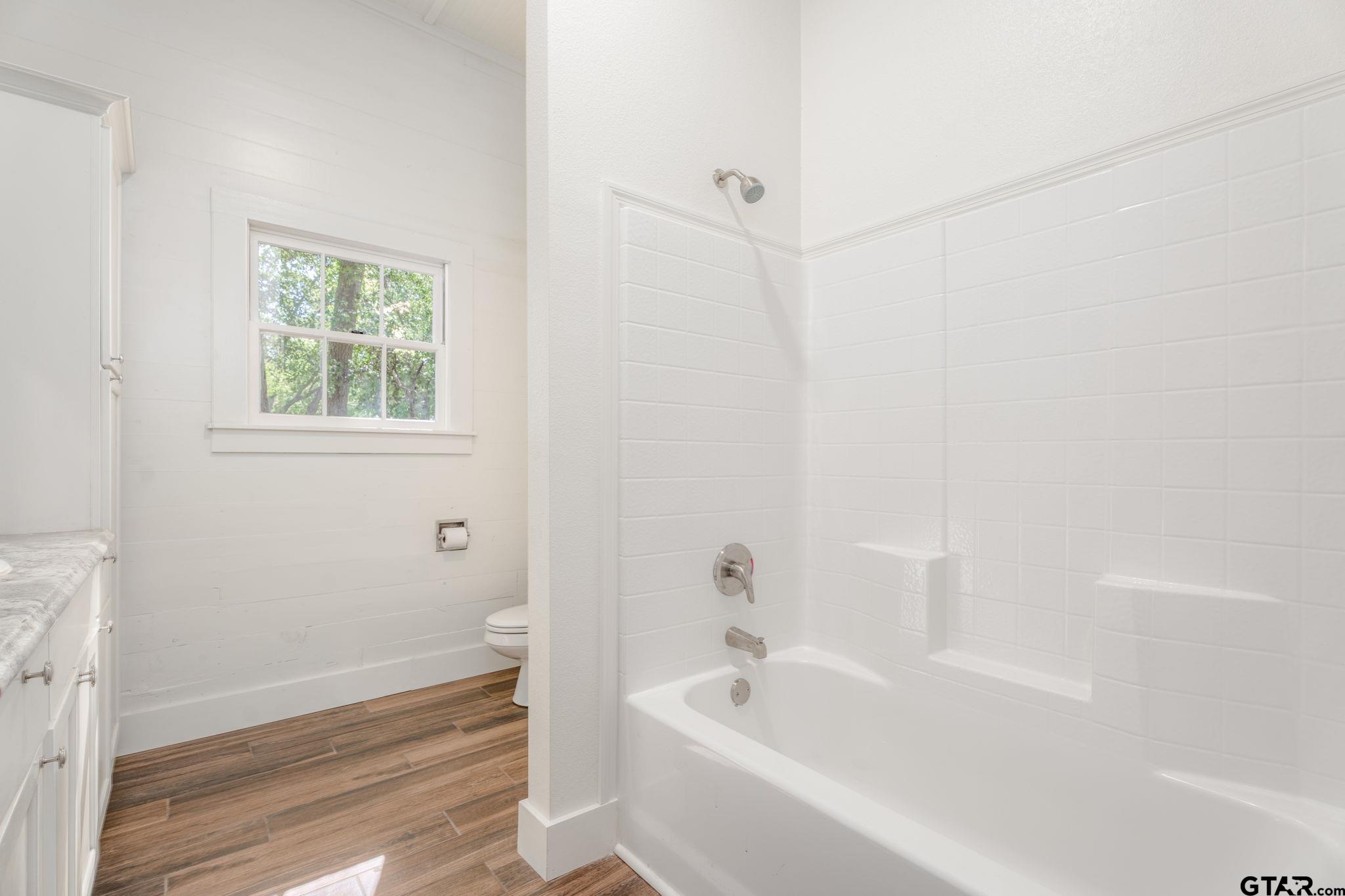 605 East Calvert Street Troup, TX 75789 - Photo 15 of 23 a white bath tub sitting next to a white sink