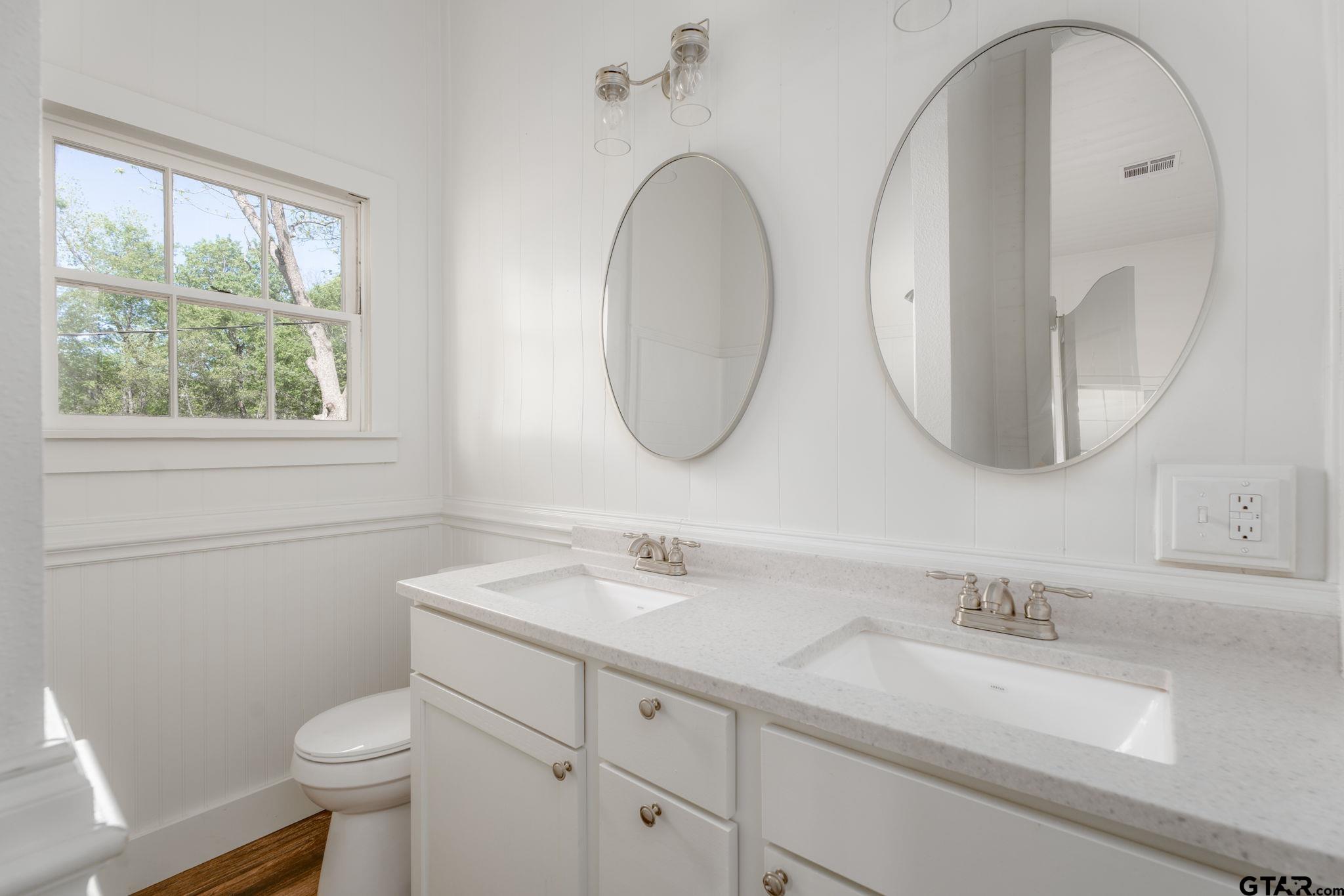 605 East Calvert Street Troup, TX 75789 - Photo 16 of 23 a bathroom with a granite countertop toilet sink and mirror