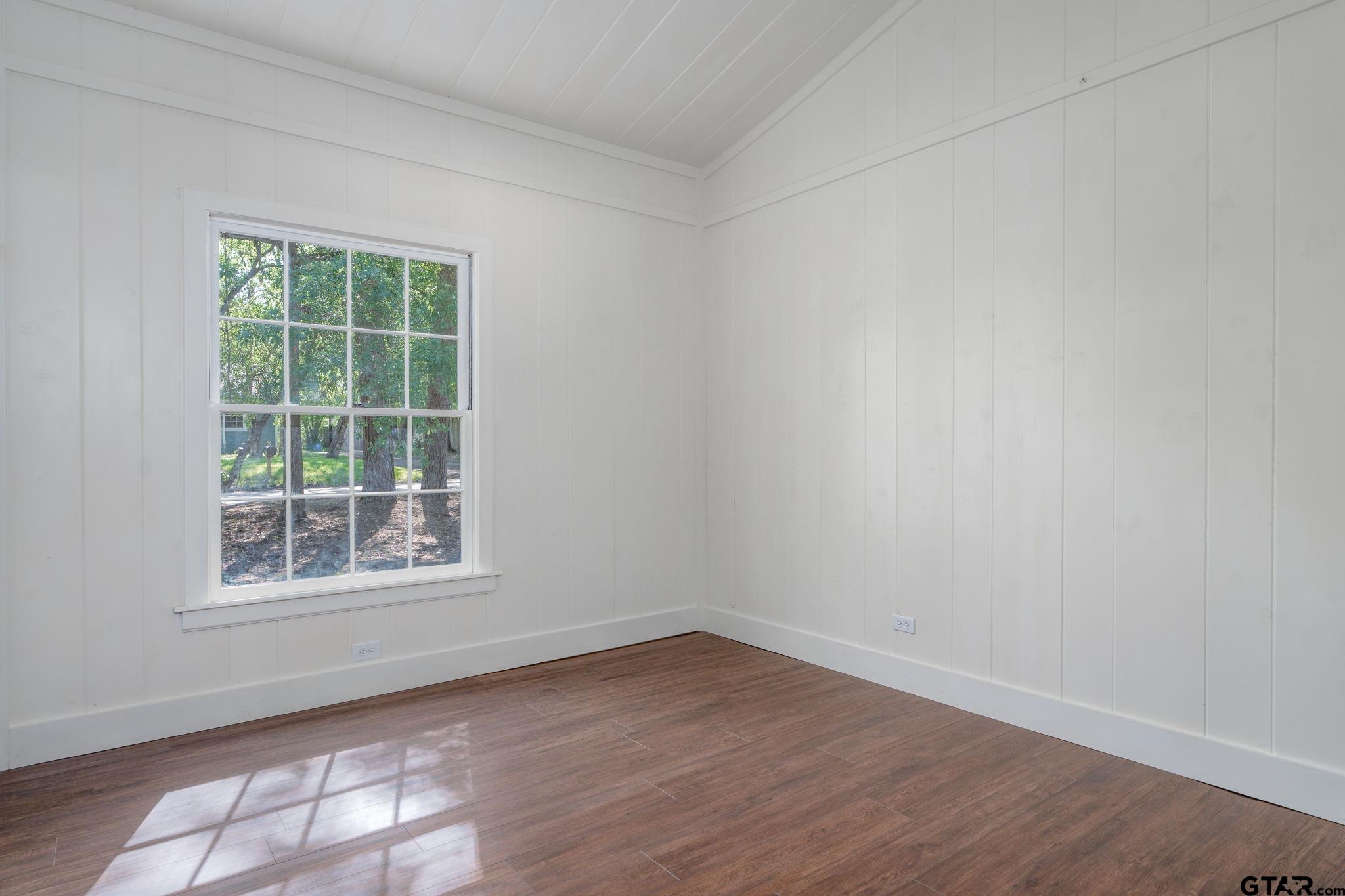 605 East Calvert Street Troup, TX 75789 - Photo 17 of 23 an empty room with wooden floor and windows