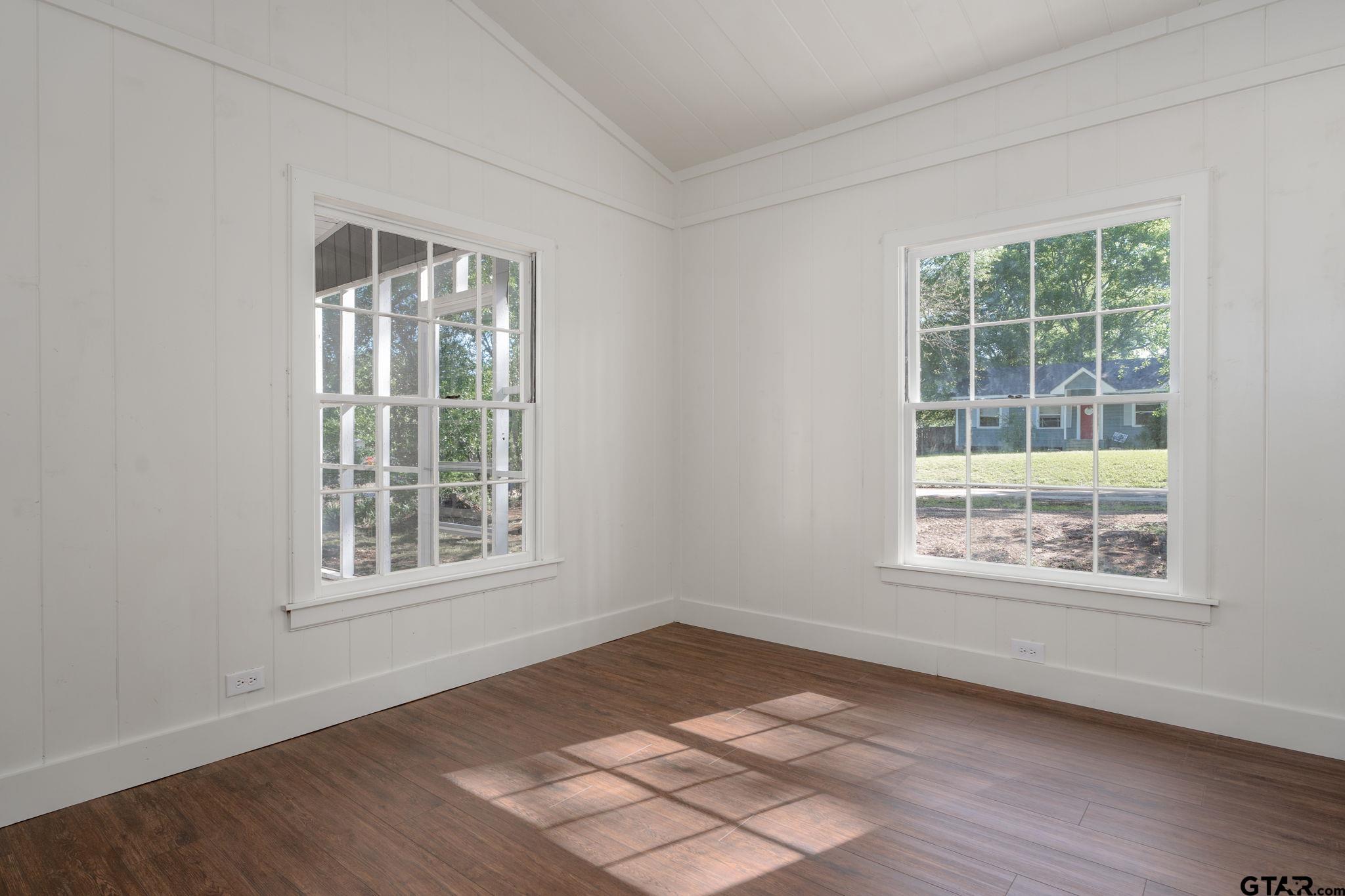 605 East Calvert Street Troup, TX 75789 - Photo 18 of 23 an empty room with wooden floor and windows