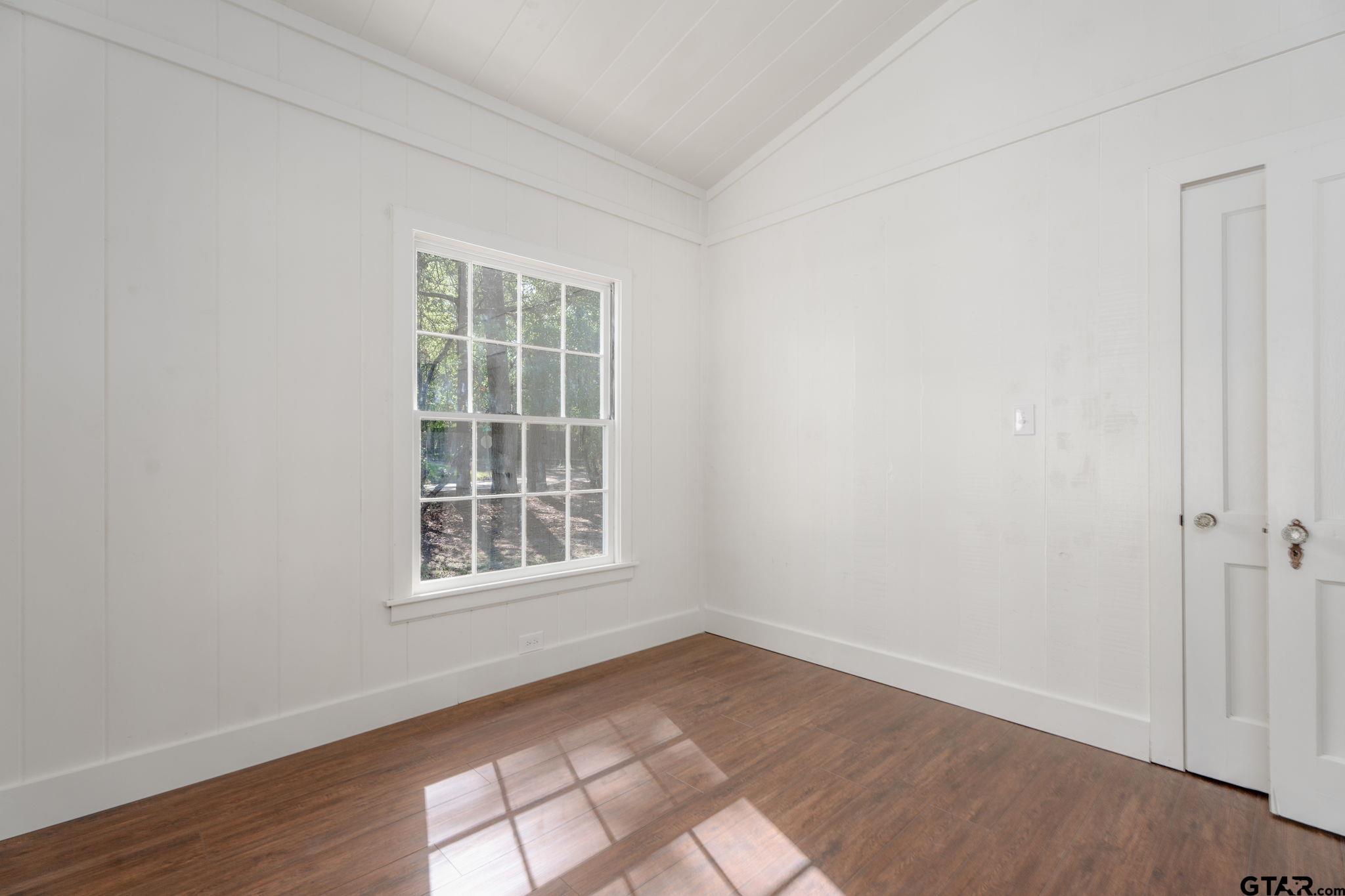 605 East Calvert Street Troup, TX 75789 - Photo 20 of 23 an empty room with wooden floor and windows