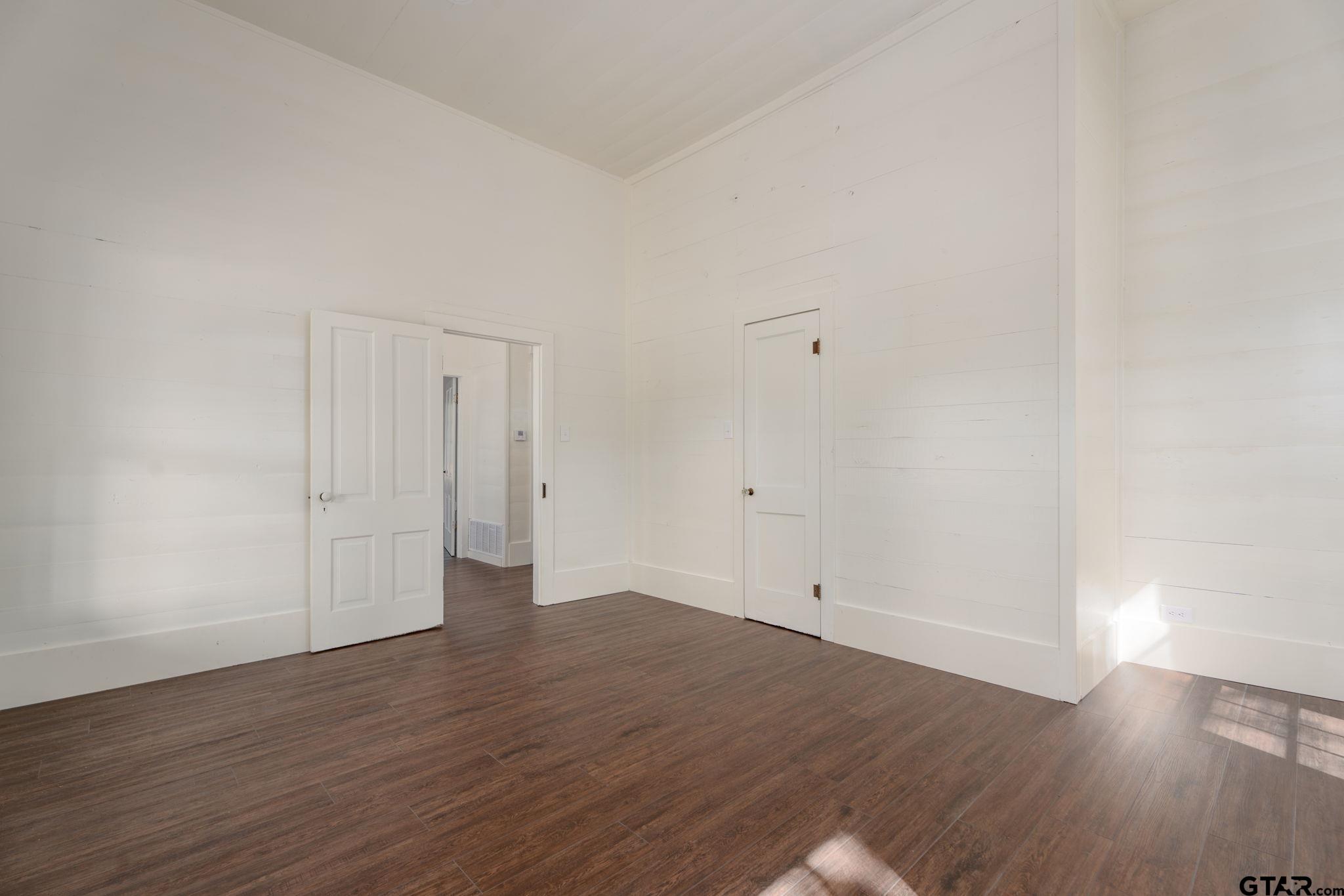 605 East Calvert Street Troup, TX 75789 - Photo 22 of 23 a view of an empty room with wooden floor