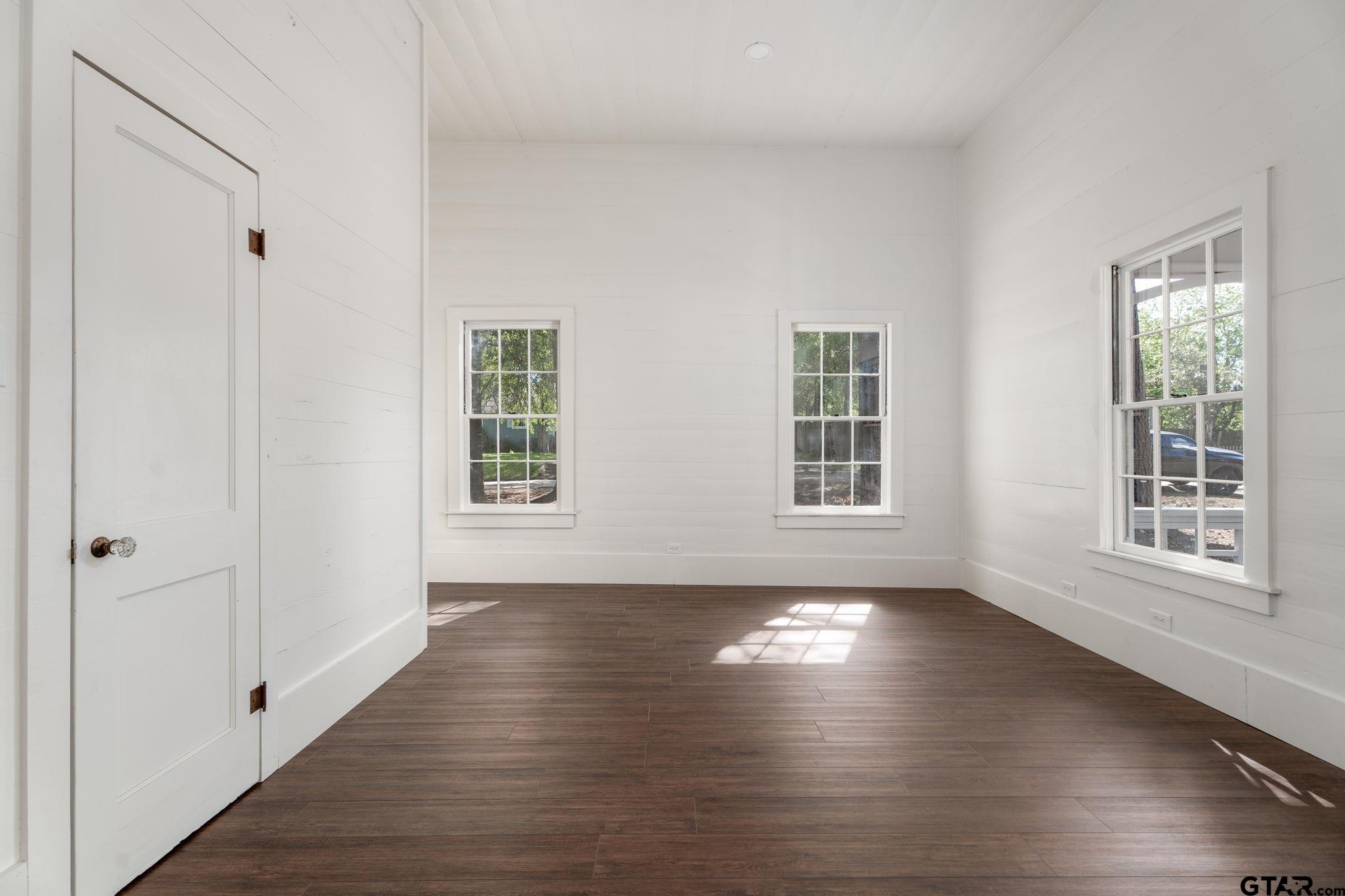 605 East Calvert Street Troup, TX 75789 - Photo 23 of 23 a view of an empty room with wooden floor and a window