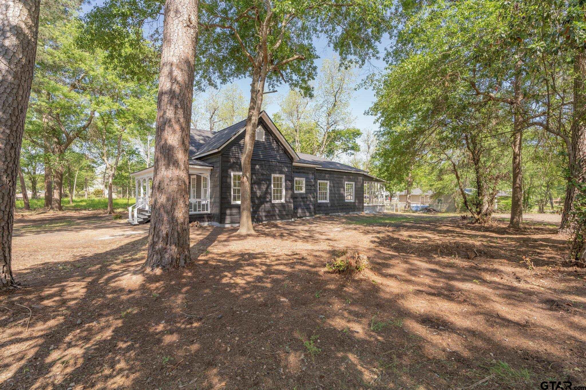 605 East Calvert Street Troup, TX 75789 - Photo 4 of 23 a front view of a house with a garden