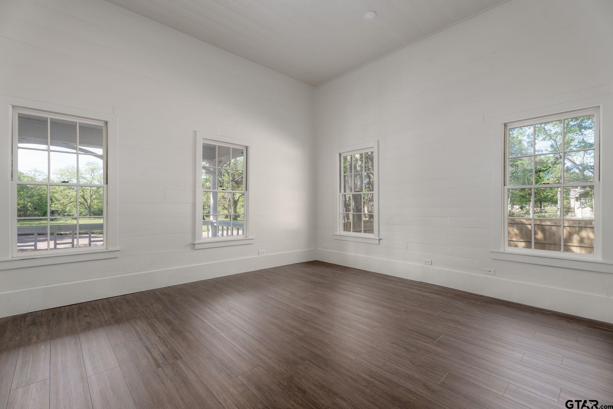 605 East Calvert Street Troup, TX 75789 - Photo 8 of 23 a view of an empty room with wooden floor and a window