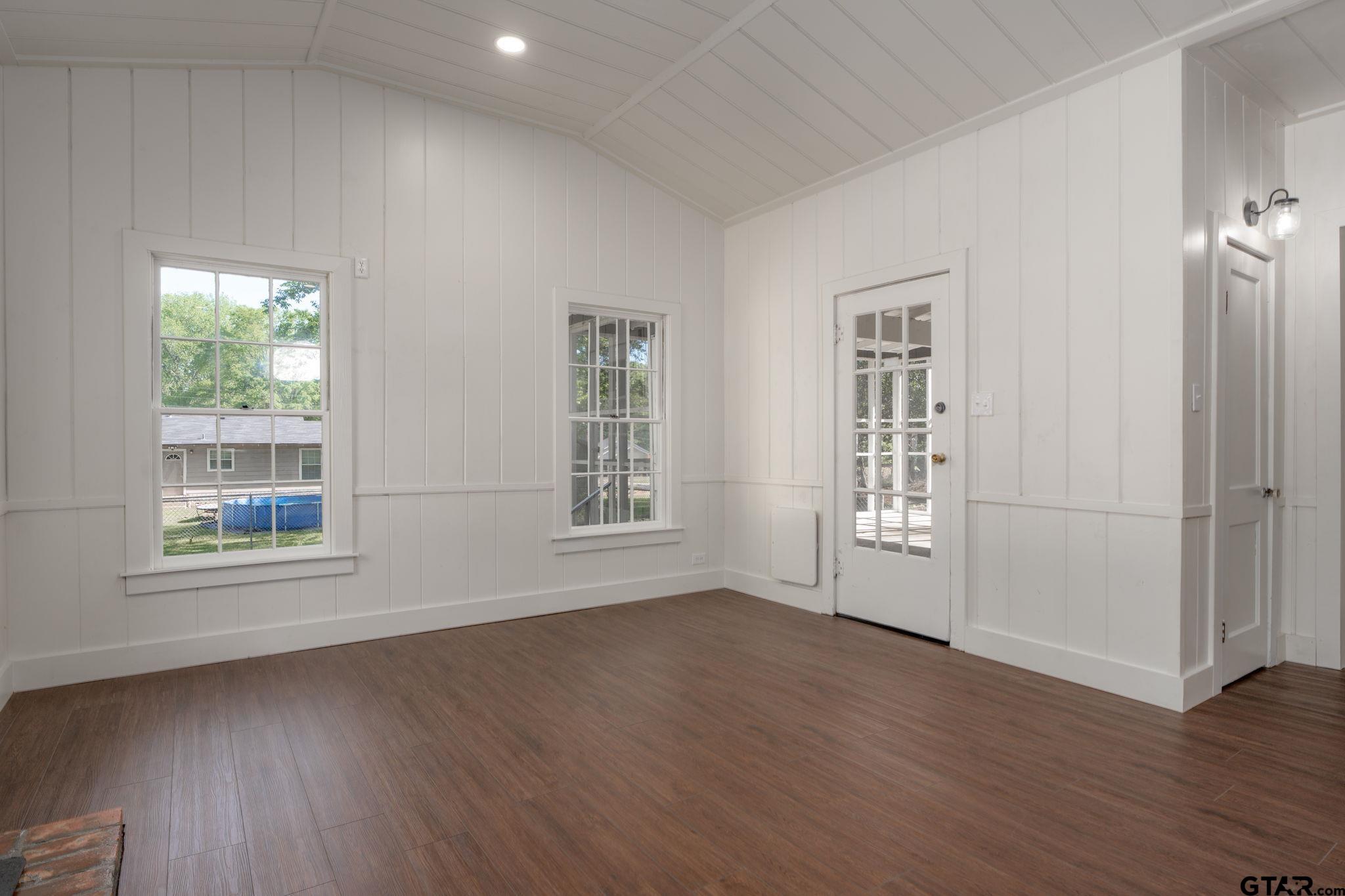 605 East Calvert Street Troup, TX 75789 - Photo 10 of 23 an empty room with wooden floor and windows