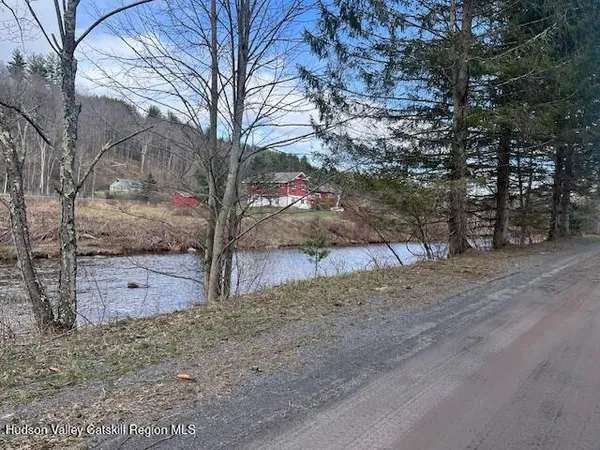 a view of a yard with wooden fence