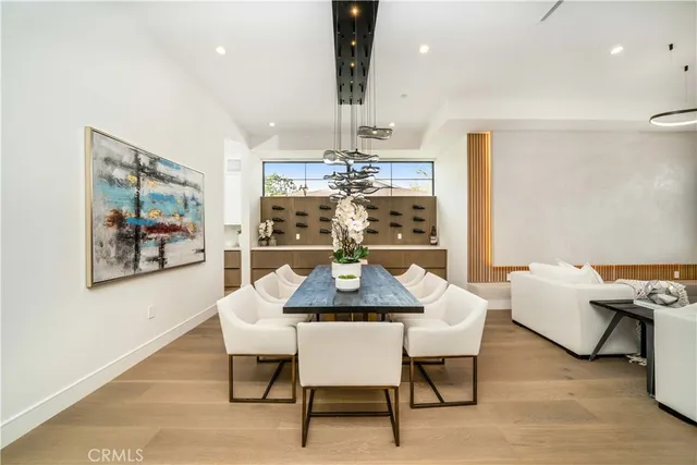 a view of a dining room with furniture wooden floor and chandelier