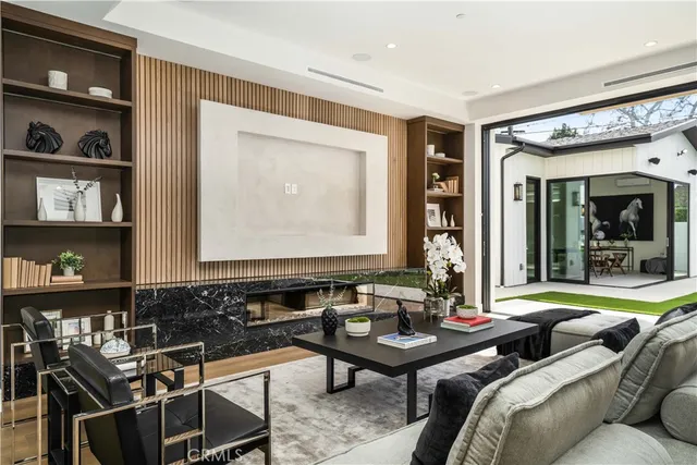 a living room with furniture and a book shelf