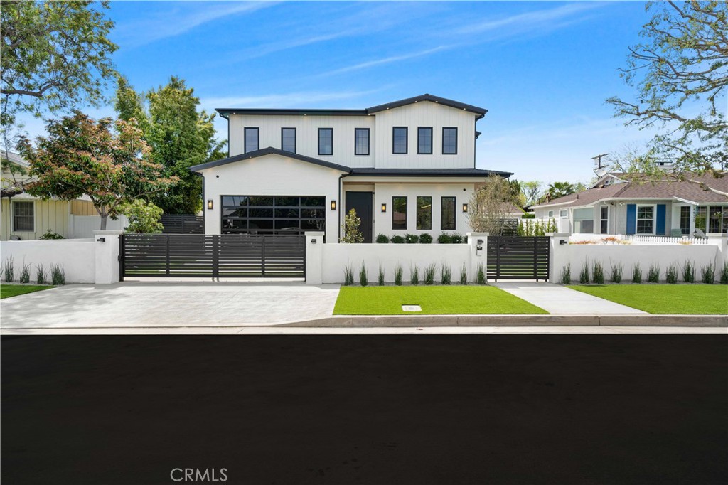 4919 Mammoth Avenue Sherman Oaks, CA 91423 - Photo 2 of 29 a front view of a house with a yard and garage