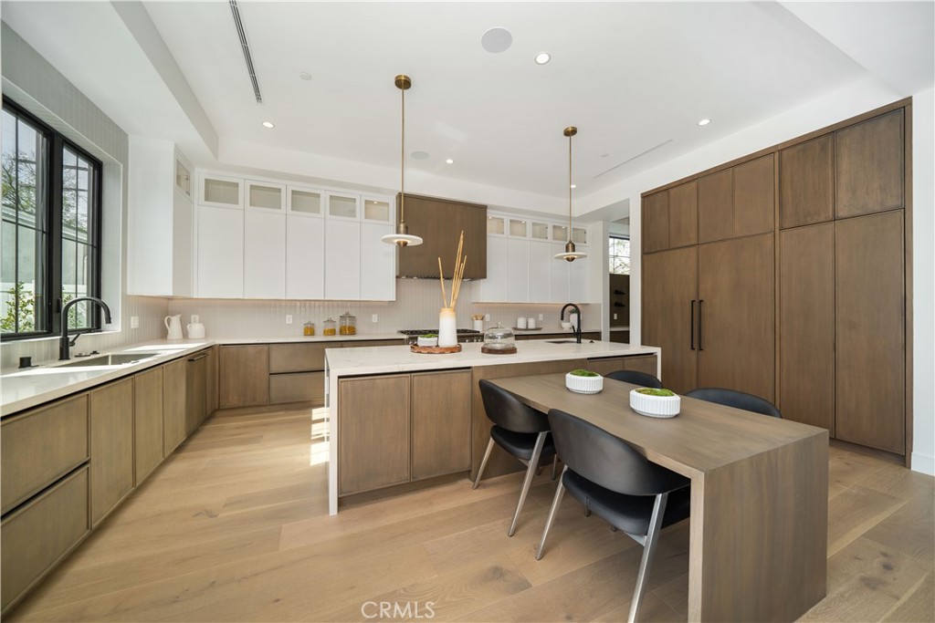 4919 Mammoth Avenue Sherman Oaks, CA 91423 - Photo 23 of 29 a kitchen with a sink refrigerator and chairs