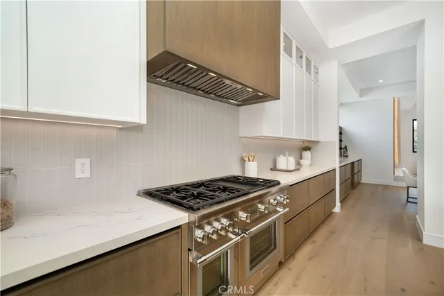 a kitchen with stainless steel appliances a sink a stove and a refrigerator