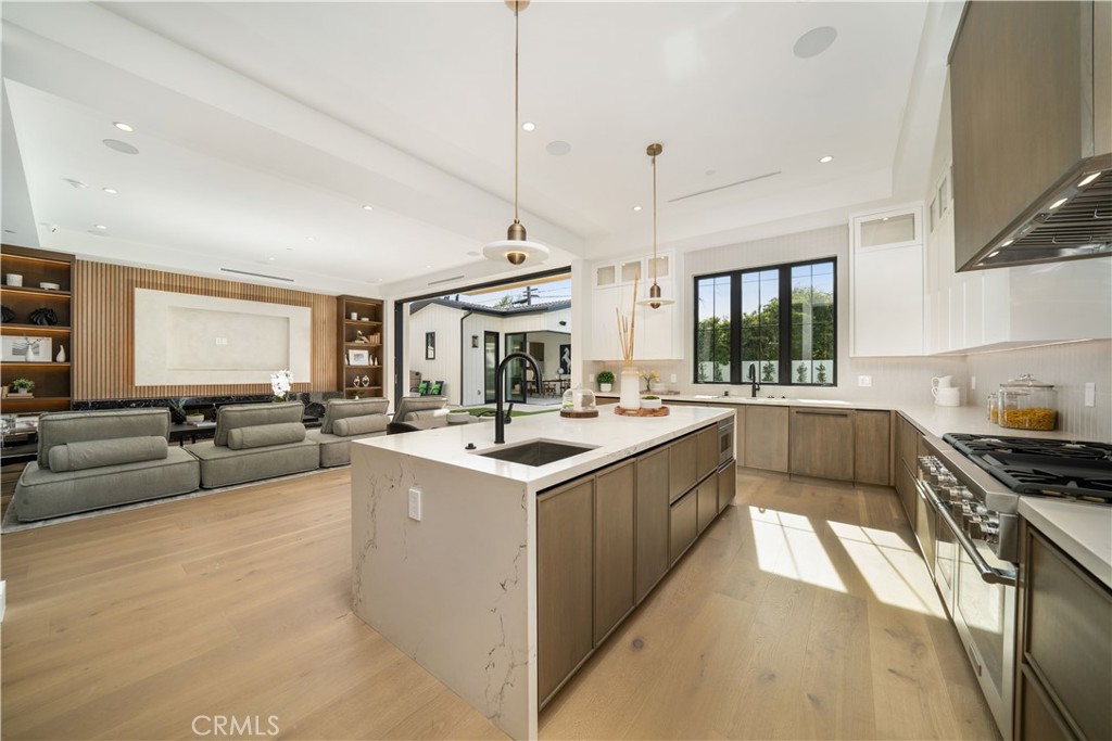 4919 Mammoth Avenue Sherman Oaks, CA 91423 - Photo 25 of 29 a kitchen with stainless steel appliances granite countertop a sink a stove and a refrigerator