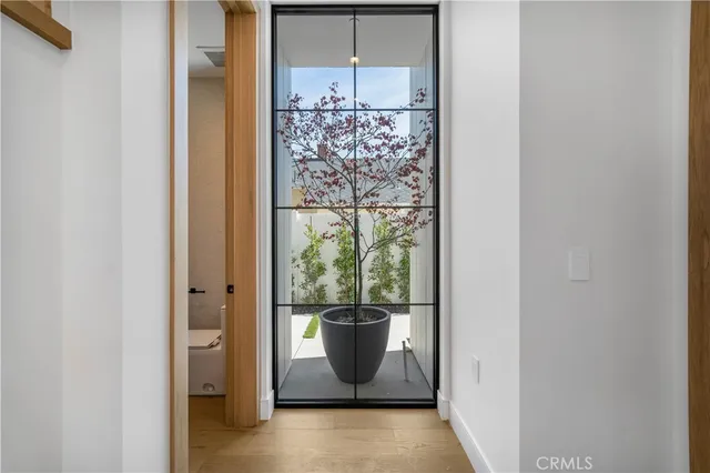 a view of a glass door with a glass door and garden