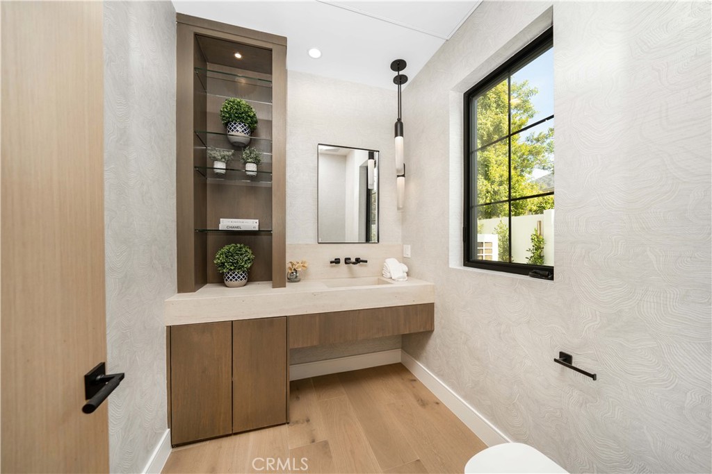 4919 Mammoth Avenue Sherman Oaks, CA 91423 - Photo 29 of 29 a bathroom with a bathtub a mirror and a sink