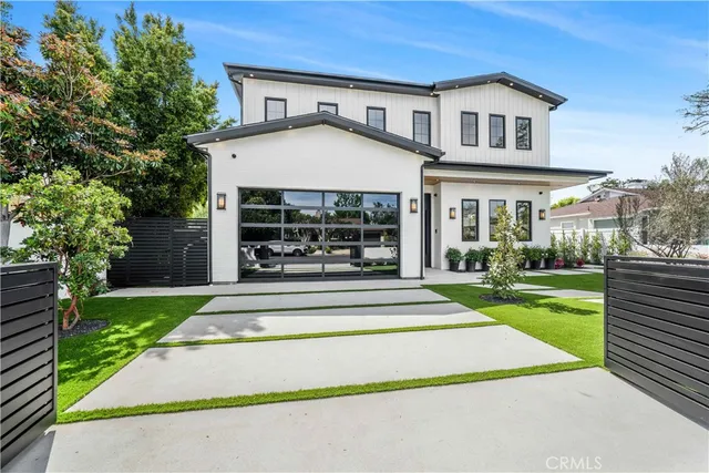a view of a house with a yard patio and a fountain