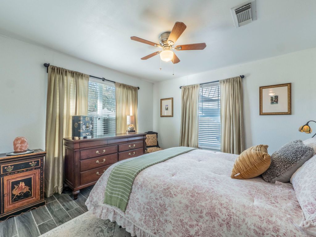11012 3rd Street Jonestown, TX 78645 - Photo 13 of 26 a bedroom with a bed and a chandelier