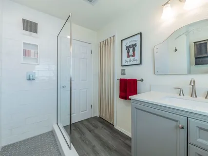a bathroom with a shower and a sink