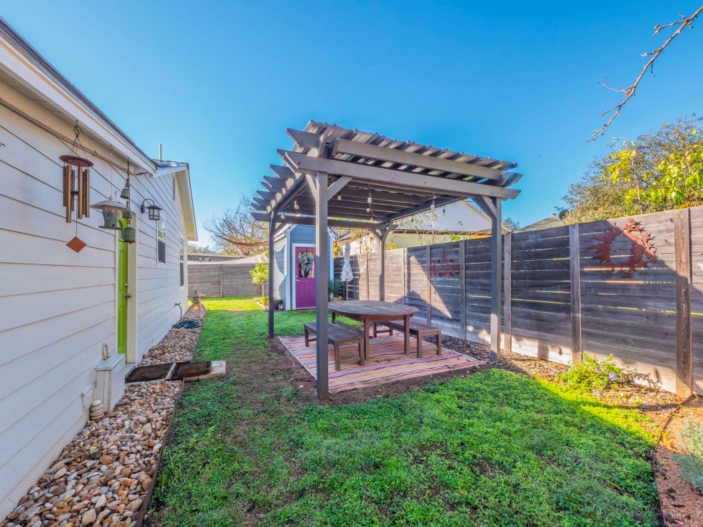 11012 3rd Street Jonestown, TX 78645 - Photo 21 of 26 a view of a chair and table in backyard of the house