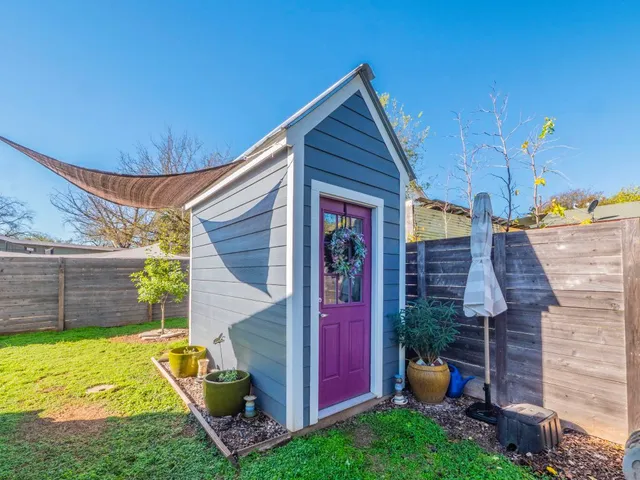a view of a backyard with plants and a patio