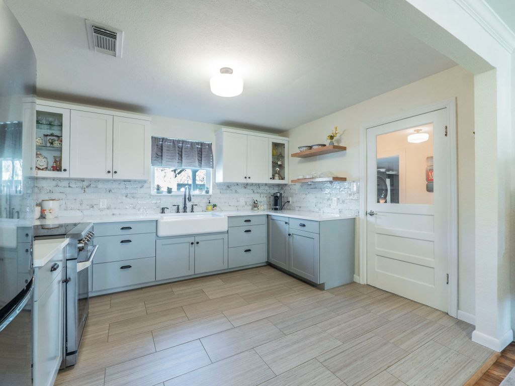 11012 3rd Street Jonestown, TX 78645 - Photo 7 of 26 a kitchen with cabinets appliances and a sink