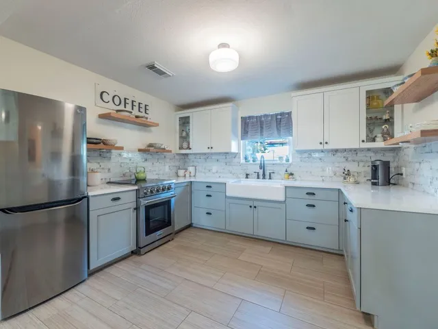 a kitchen with cabinets appliances and a sink