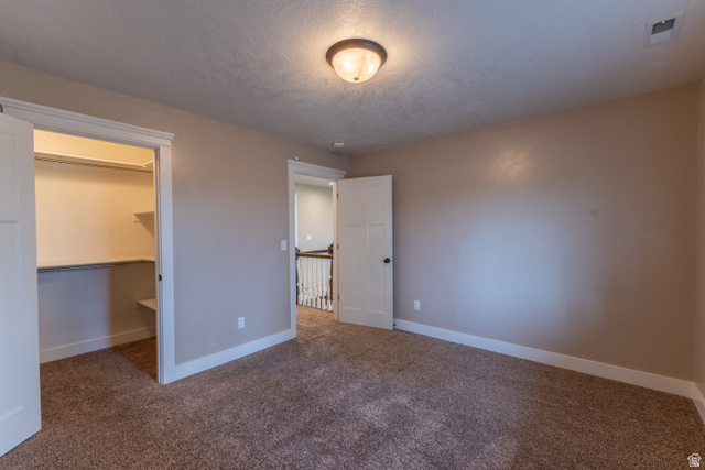 3565 West 1350th Street North Vernal, UT 84078 - Photo 28 of 54 Carpeted room featuring a built-in closet with shelving and hanging rod