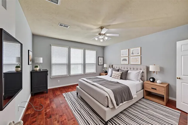 a bedroom with a bed and a chandelier