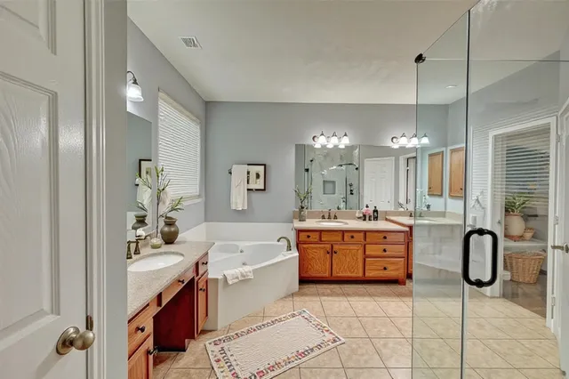 a large bathroom with a sink a tub and shower