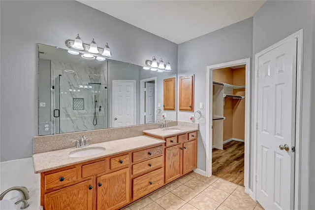 a spacious bathroom with a double vanity sink and a mirror