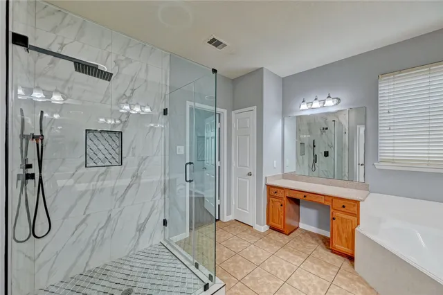 a spacious bathroom with a tub shower and sink