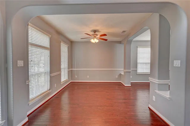 wooden floor in an empty room with a window