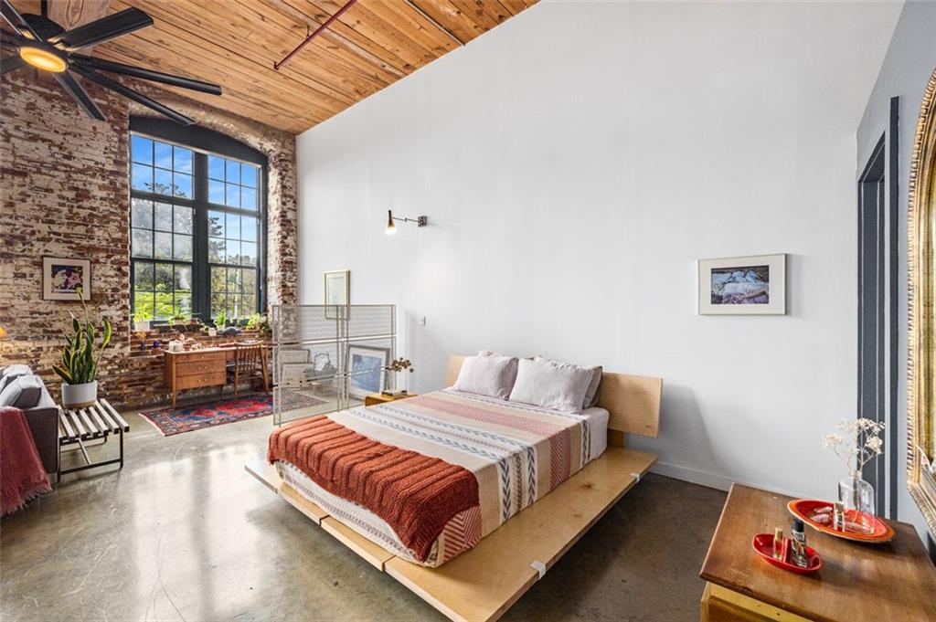 170 Boulevard Southeast, Unit 211H Atlanta, GA 30312 - Photo 14 of 49 a spacious bedroom with a bed a couch and a large window