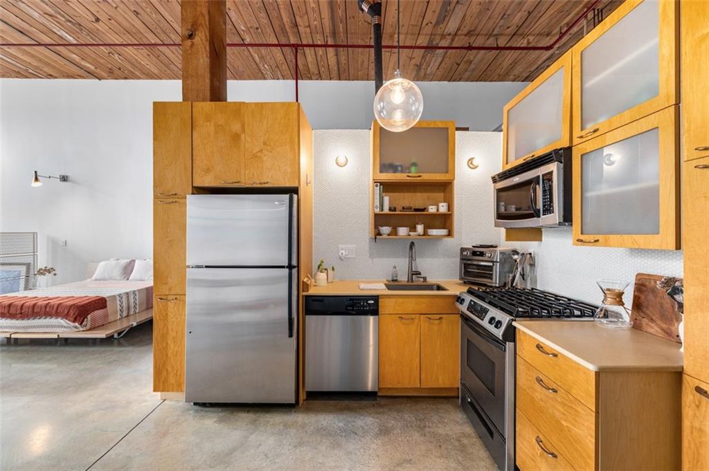 170 Boulevard Southeast, Unit 211H Atlanta, GA 30312 - Photo 20 of 49 a kitchen with a refrigerator and a stove
