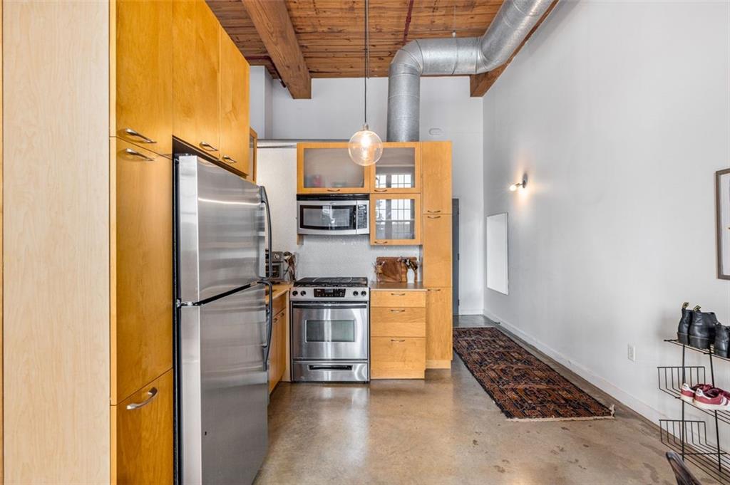 170 Boulevard Southeast, Unit 211H Atlanta, GA 30312 - Photo 21 of 49 a kitchen with stainless steel appliances a refrigerator and a stove