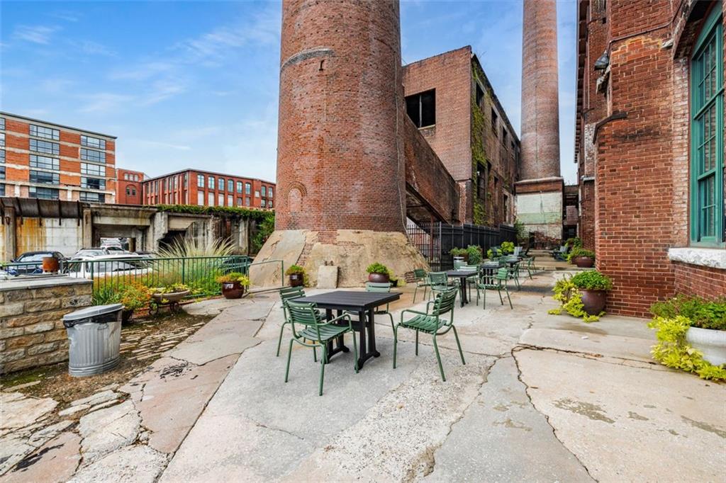 170 Boulevard Southeast, Unit 211H Atlanta, GA 30312 - Photo 34 of 49 a view of a patio with a table and chairs and potted plants